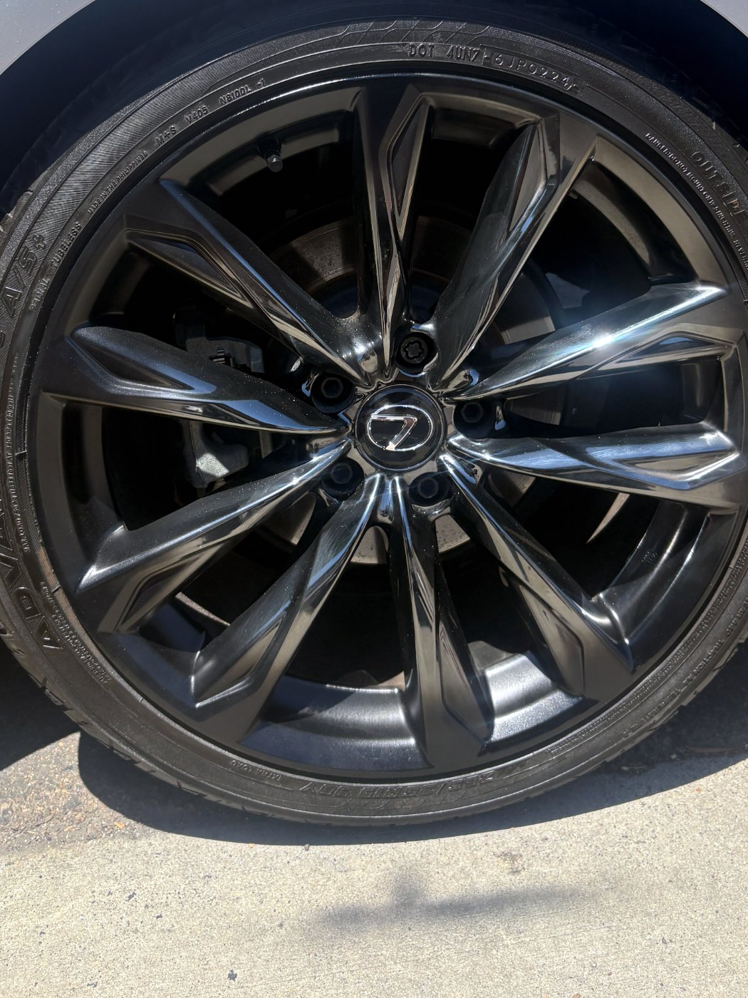 The same Lexus alloy wheel after curb rash repair, lip and spoke edges refinished