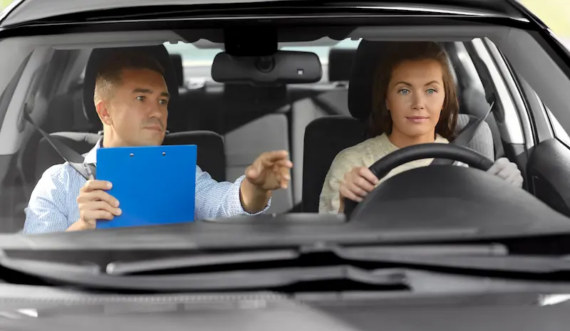 Instructor coaching a student during road test warm-up in New Jersey