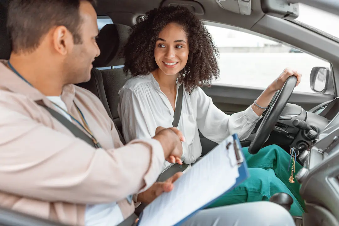 Adult student smiling in the driver's seat