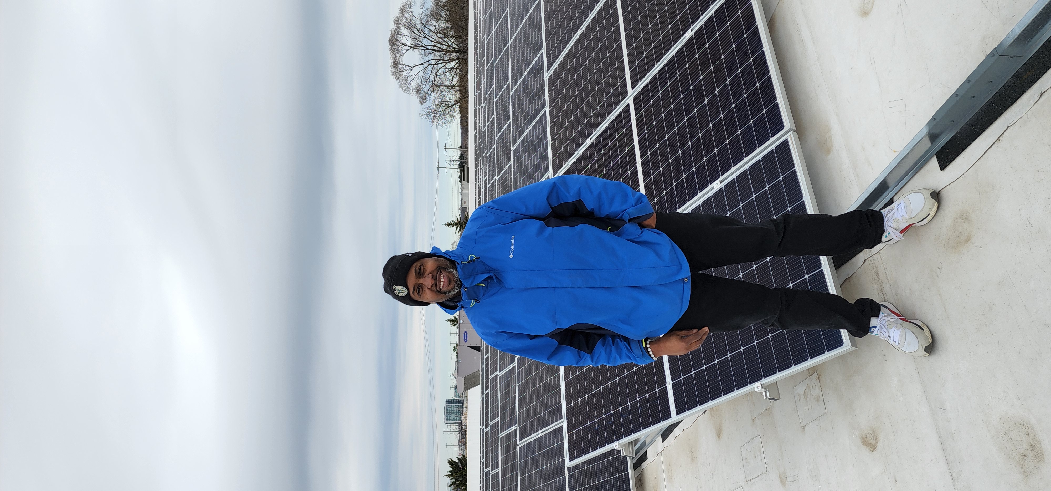 Deshea Agee on a rooftop solar array project at Outreach Community Health Center