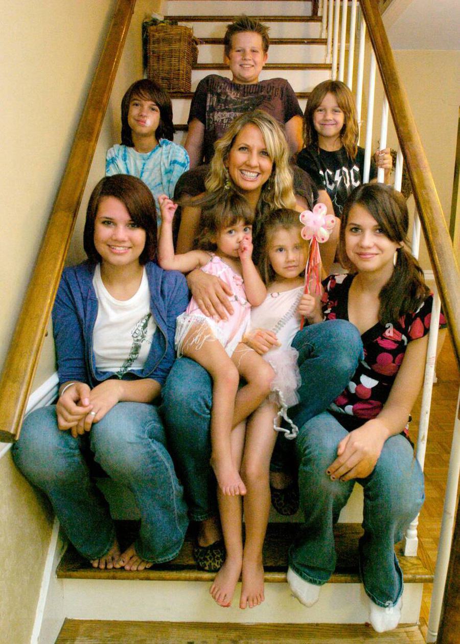 Hannah with her seven children on the stairs of their home
