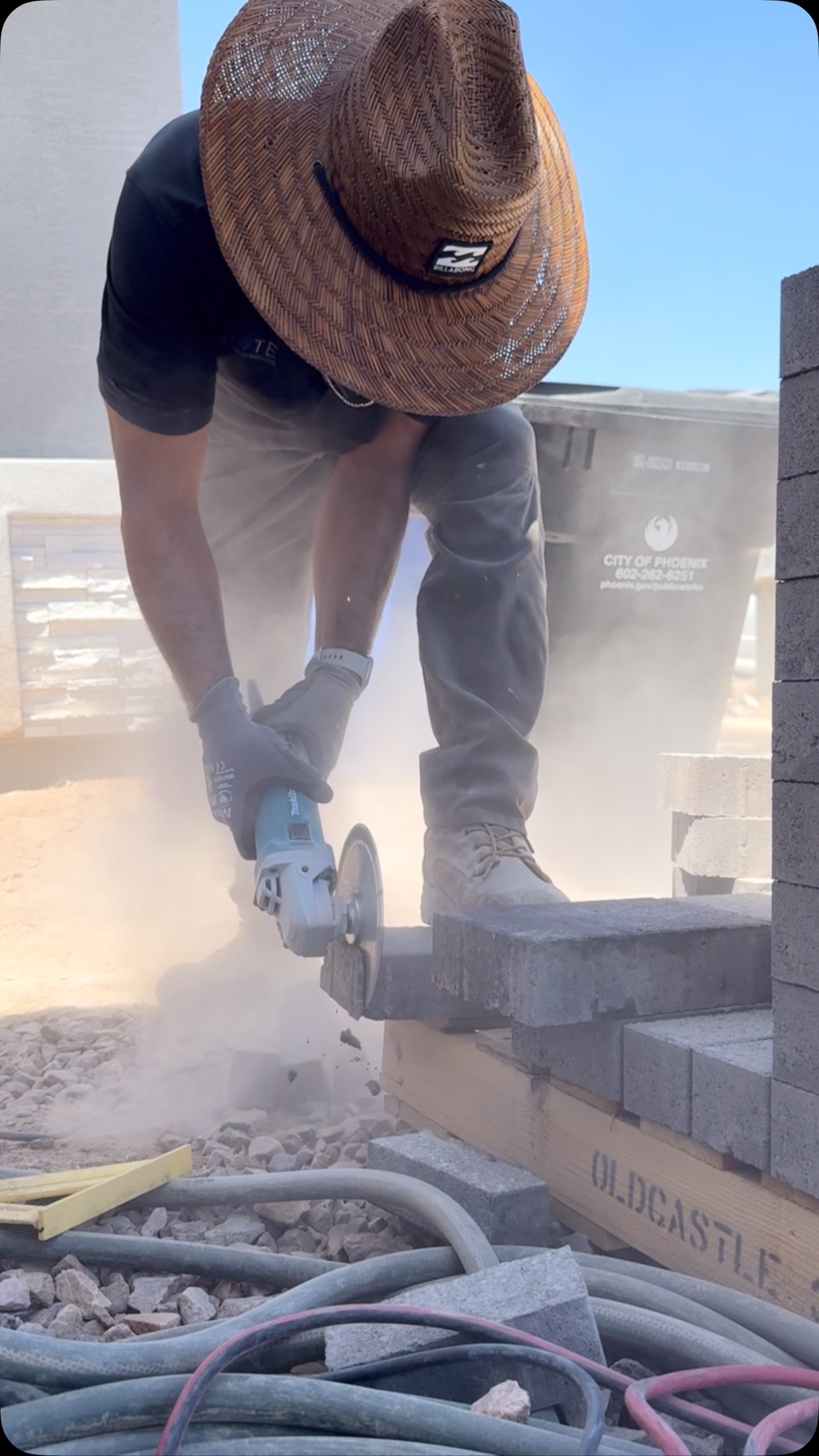 AZ Elevate craftsman cutting pavers on a Phoenix hardscaping project