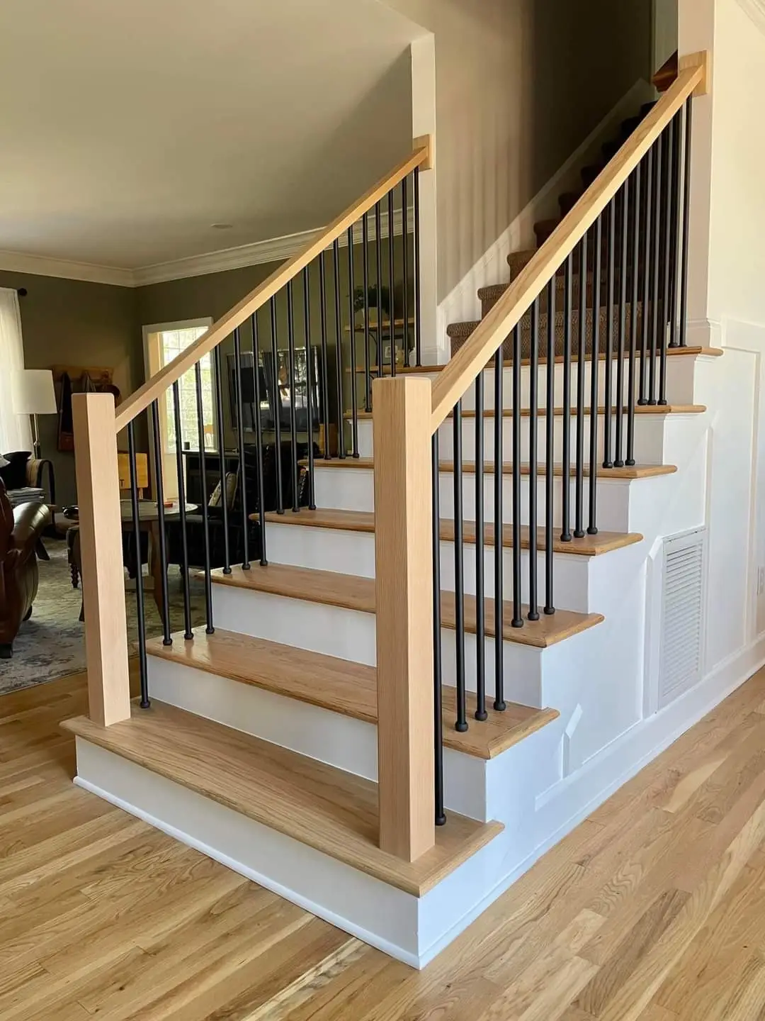 A renovated interior staircase featuring natural wood treads, white risers, and in Reading, PA by JB Plumbing HVAC & Const...