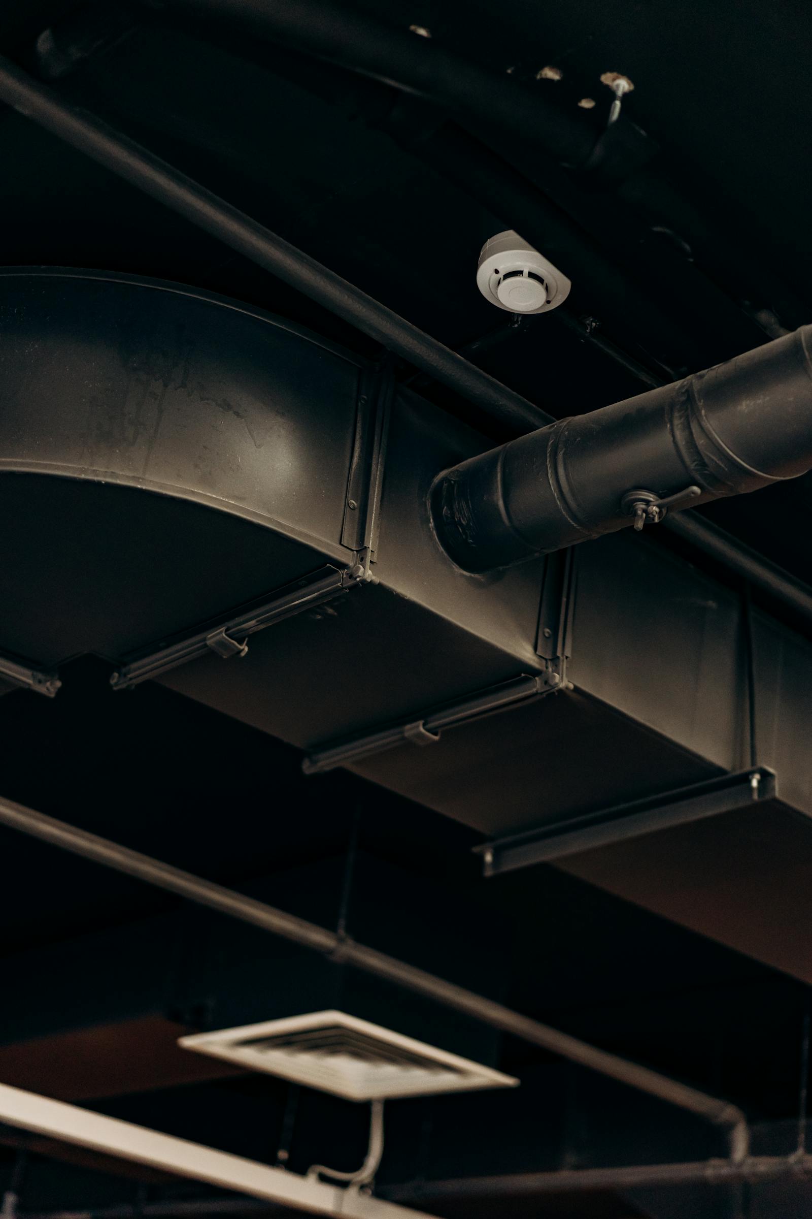 HVAC ductwork installed in a residential utility area, showing professional sheet-metal fabrication.