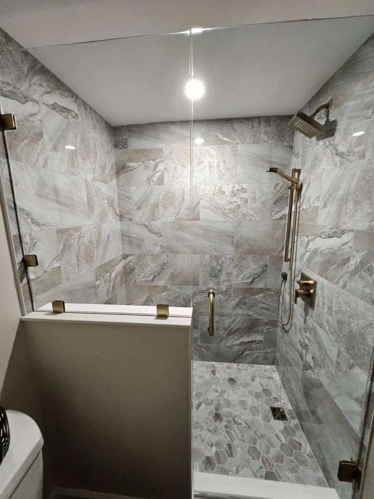 A newly remodeled walk-in shower in a bathroom, featuring large format in Reading, PA by JB Plumbing HVAC & Construction