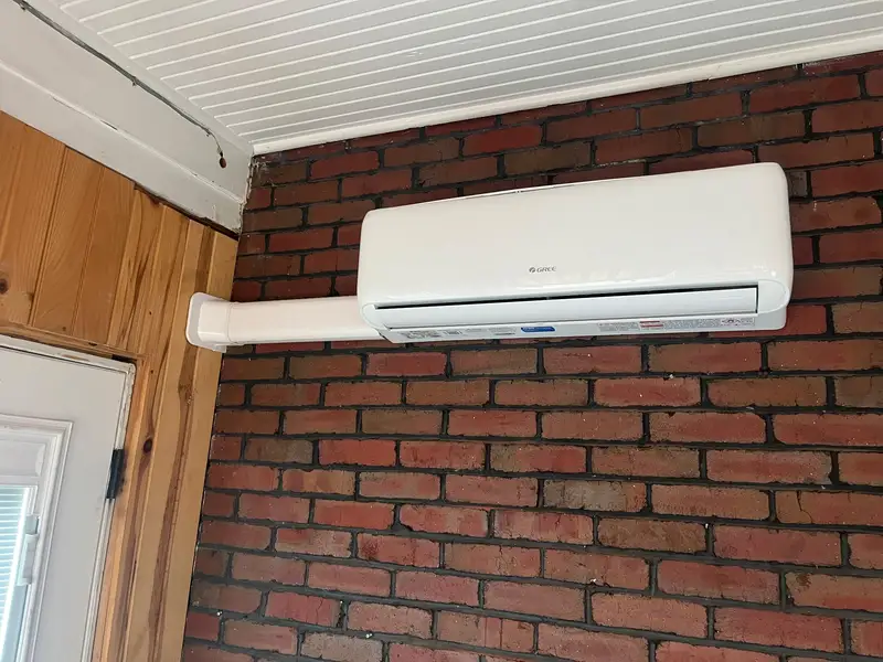 A wall-mounted Gree ductless mini split indoor head unit installed in a home.