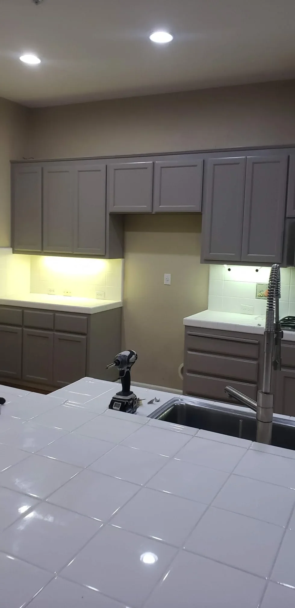 Upper and lower kitchen cabinets painted gray