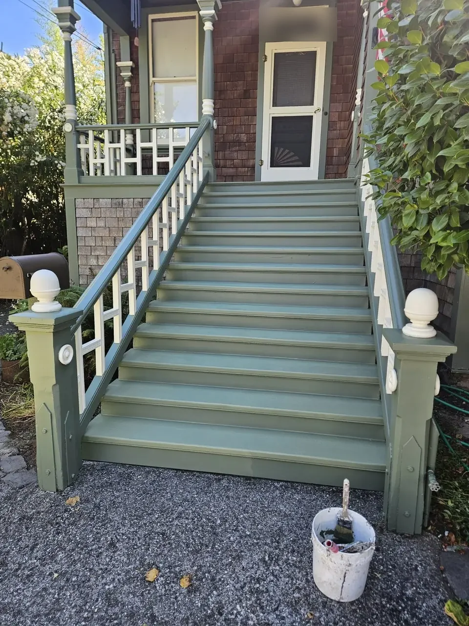 Victorian porch stairs painted sage green with white balusters