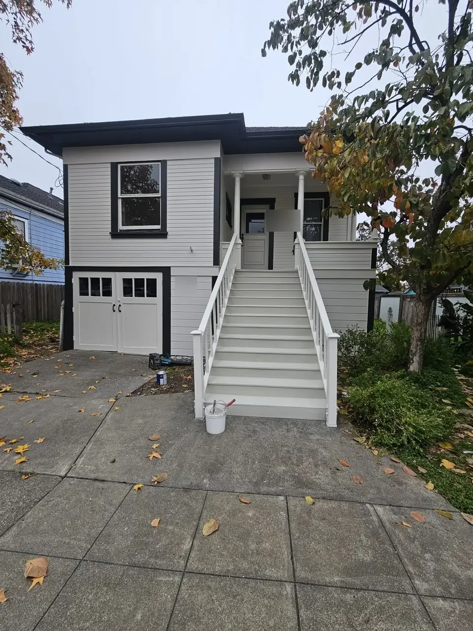 Classic home repainted in soft white with black trim