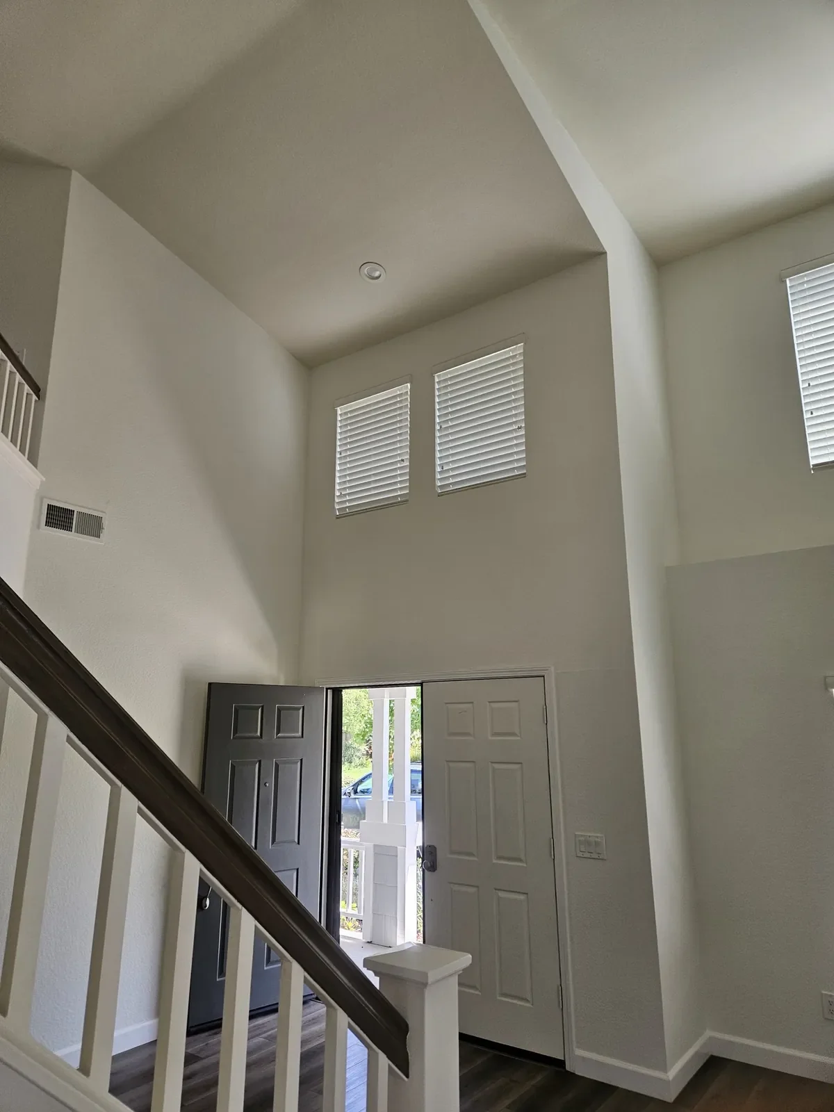 Two-story entryway with freshly painted walls and white trim