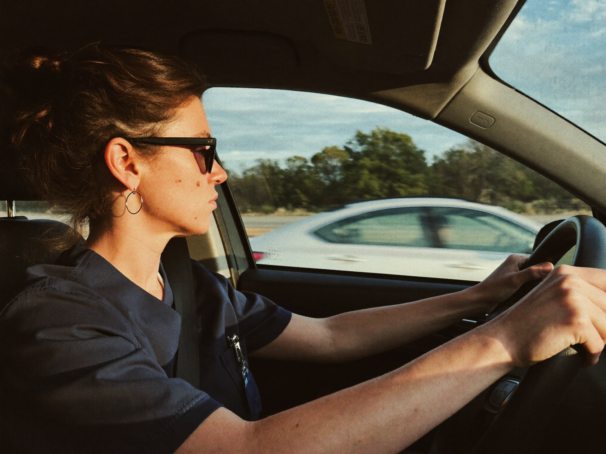 Driving home after a night shift with sunglasses on