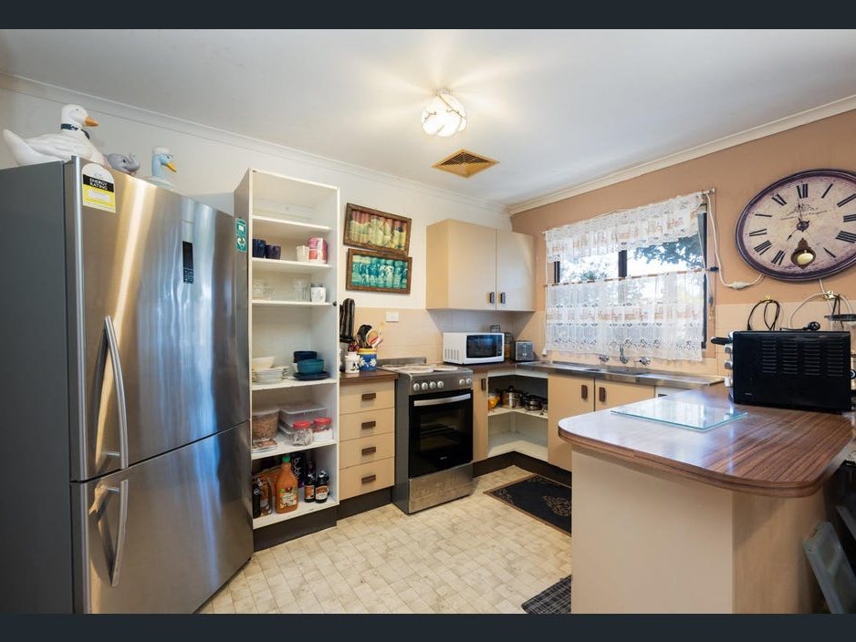 The kitchen before: dated cabinets and benchtop