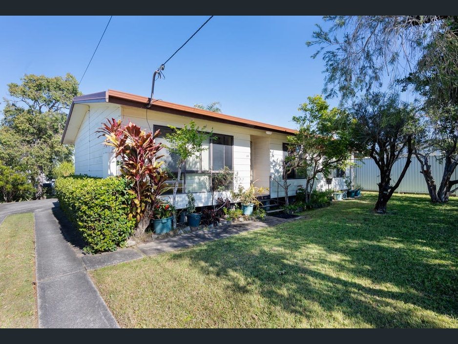 The second house before: tired fibro, overgrown garden