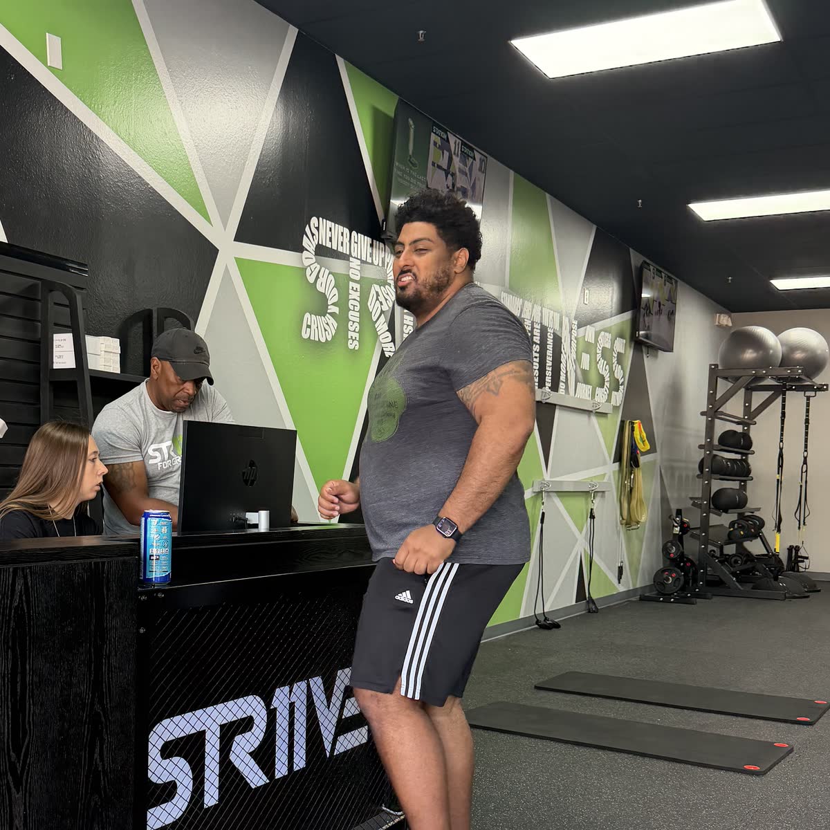 A member checking in at the Strive 11 front desk.