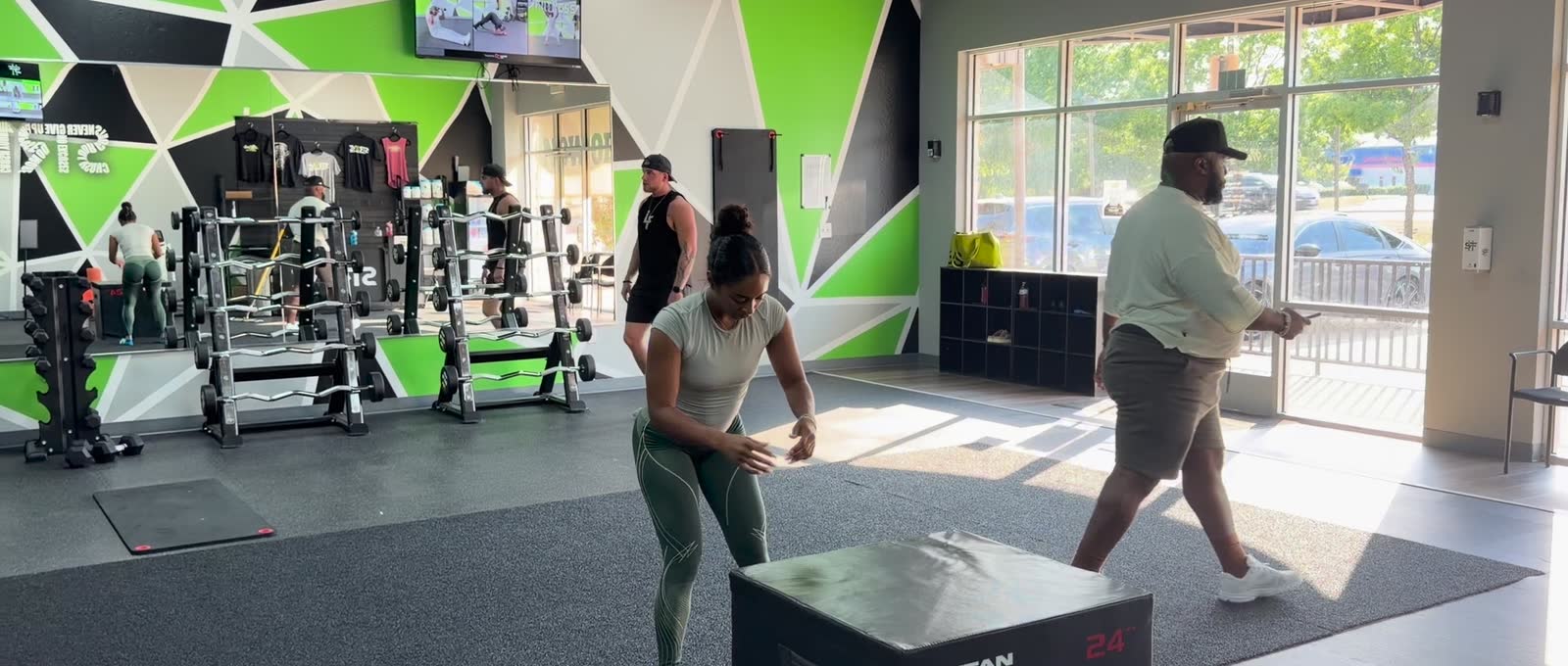 A member setting up for a box jump on the training floor.