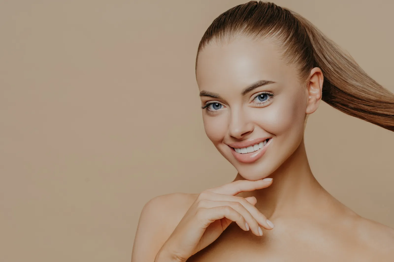 Smiling woman with long blonde hair, Invisalign clear aligners in Essex