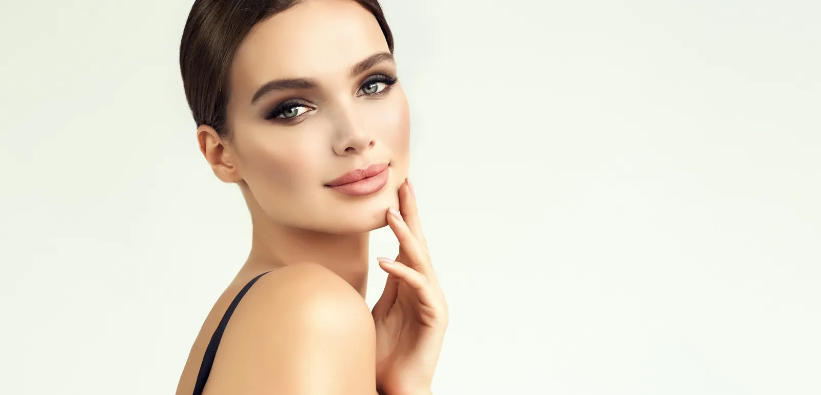 Woman with sleek dark hair and a calm smile, about Smile and Face