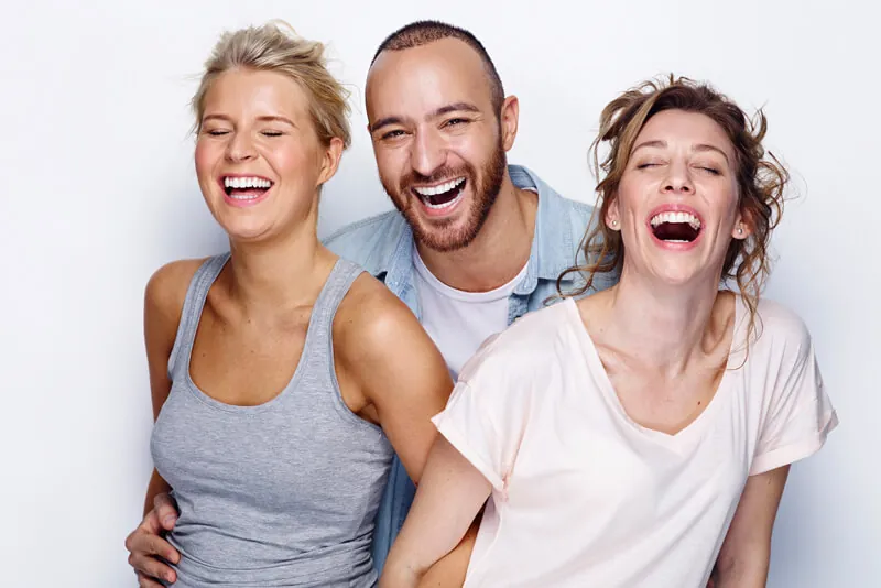 Group of friends laughing together with confident smiles