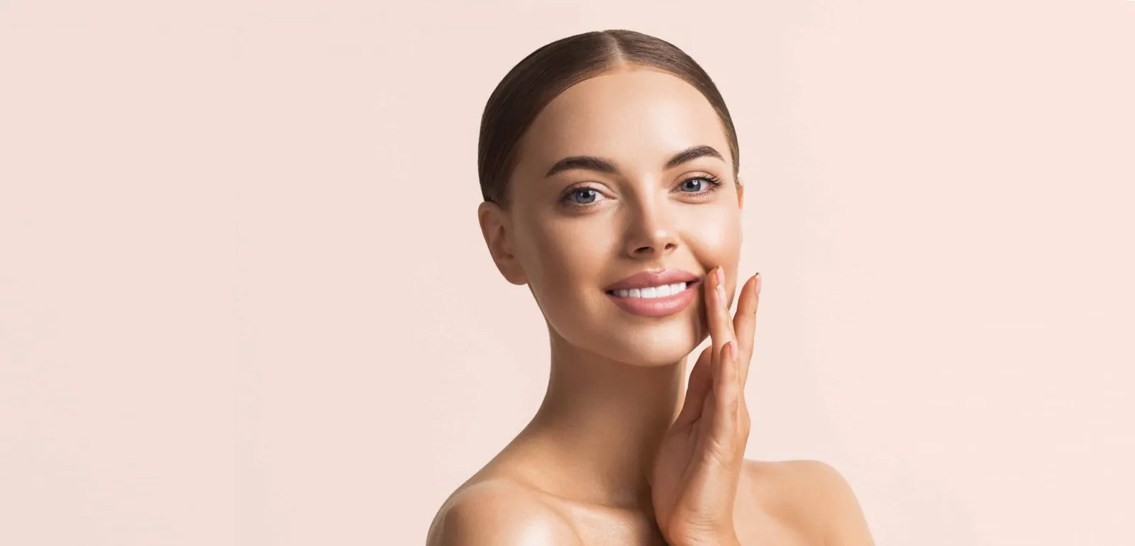 Woman with sleek hair and a soft smile, dental crowns in Essex