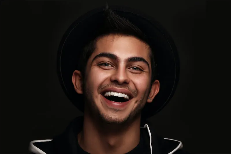 Smiling young man in a black hat