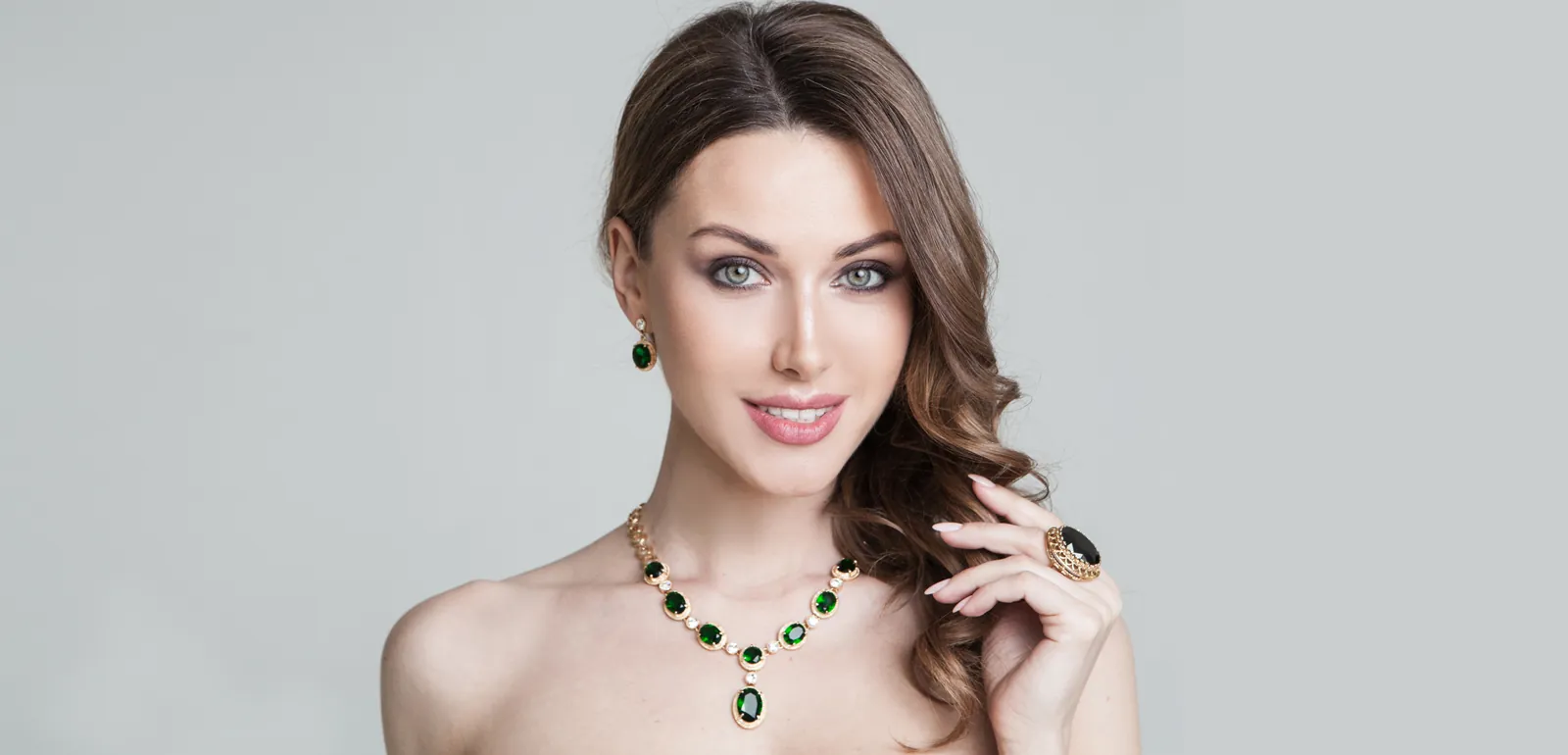 Smiling woman wearing an emerald necklace, patient feedback