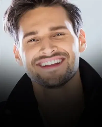 Smiling man with a bright, even smile, porcelain veneers in Essex