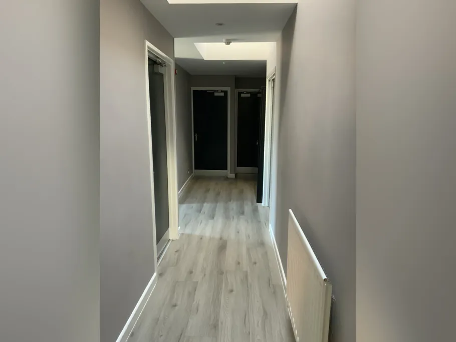 Corridor with wood-effect flooring inside the practice