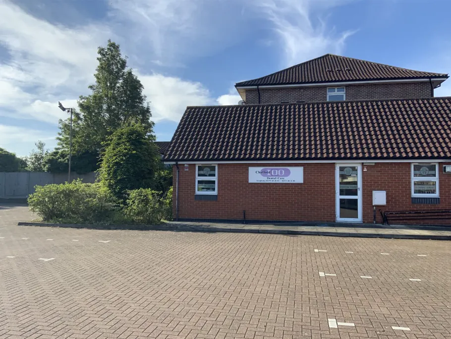Chafford Hundred Dental Care building and car park surrounded by trees