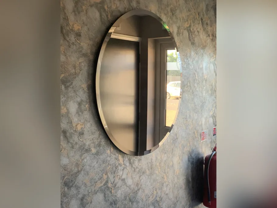 Round mirror on a textured feature wall in the practice