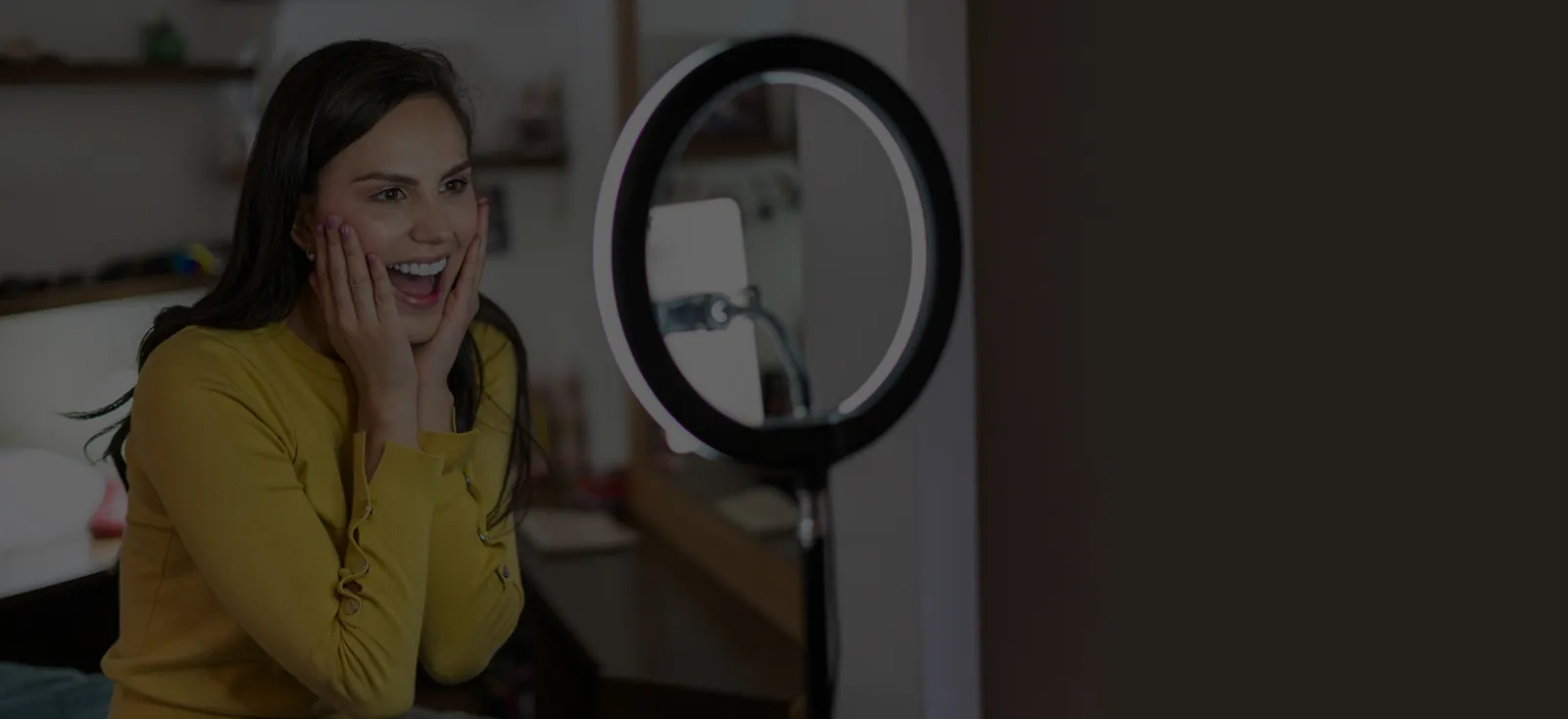 Woman taking a selfie with a ring light at home