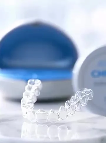 Clear aligner trays in front of an open aligner case