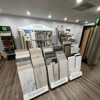 Plank flooring samples on display racks in the showroom